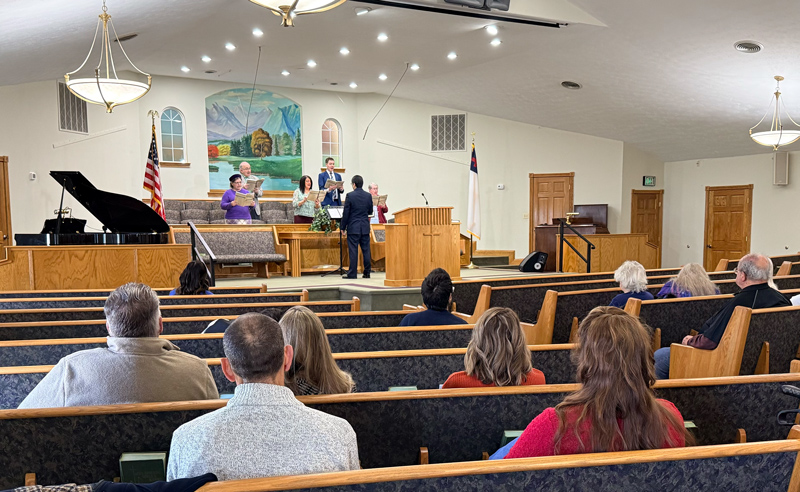 Worship service in the sanctuary of Huber Heights Baptist Temple, choir on platform with congregation seated in pews