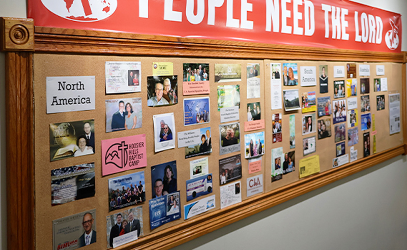 Missions prayer board at Huber Heights Baptist Temple showing supported missionaries from North America and around the world