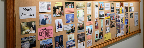 Missions prayer board at Huber Heights Baptist Temple showing supported missionaries from North America and around the world