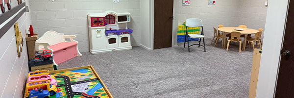 Church nursery at Huber Heights Baptist Temple with play kitchen, toys, table and chairs for young children